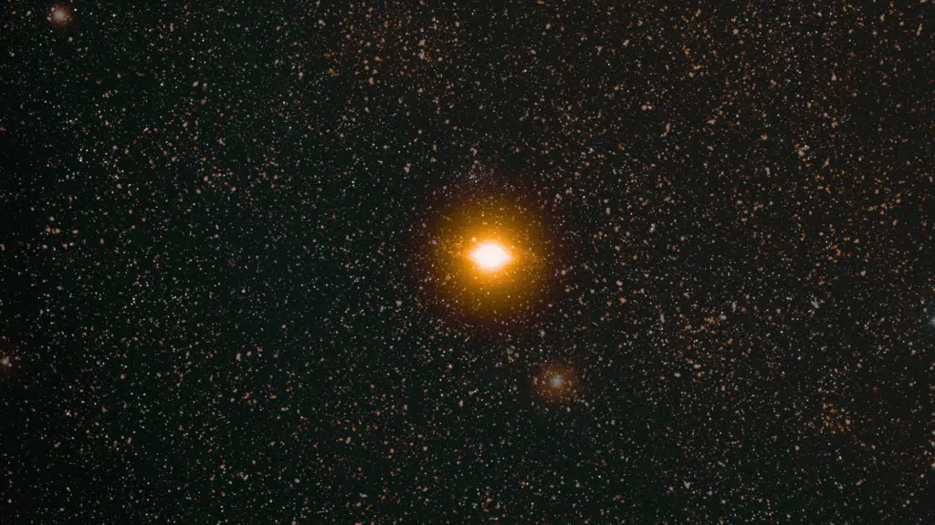 _A bright, luminous star that seems like sun dominates a dark expanse of the night sky densely filled with countless smaller white stars.