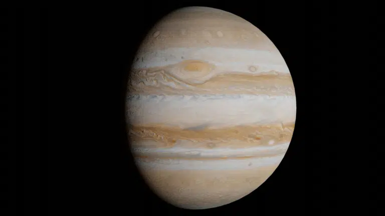 Jupiter planet's swirling beige, white, and brown cloud bands visible against deep black space