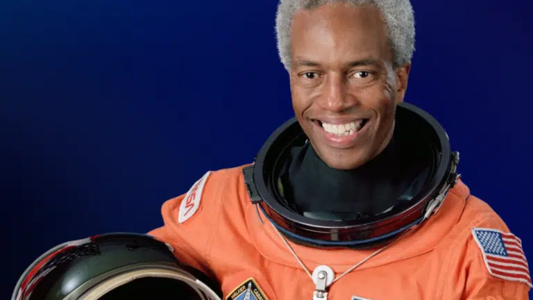 Portrait image of Astronaut Guion Bluford in orange NASA spacesuit