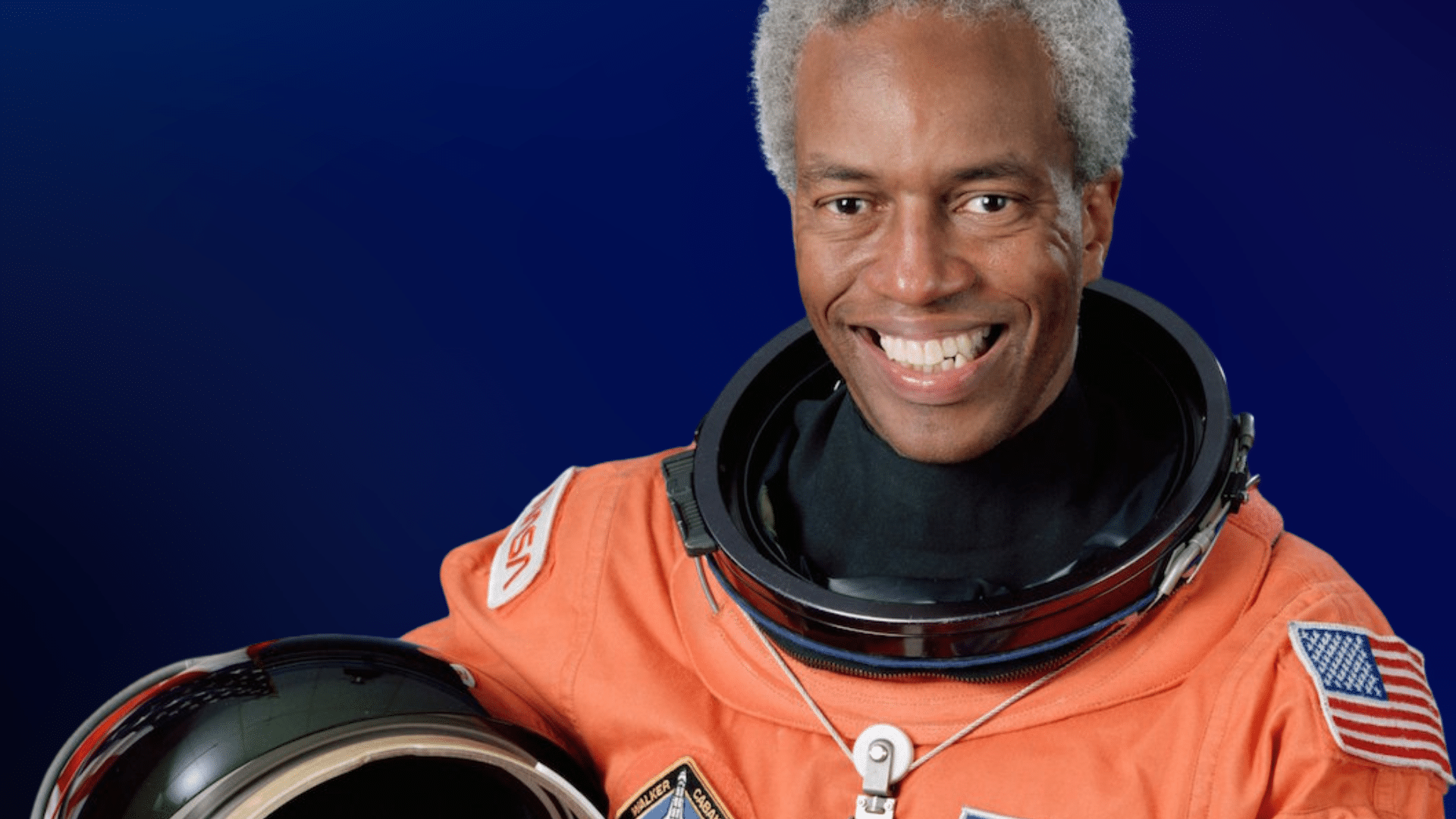 Portrait image of Astronaut Guion Bluford in orange NASA spacesuit