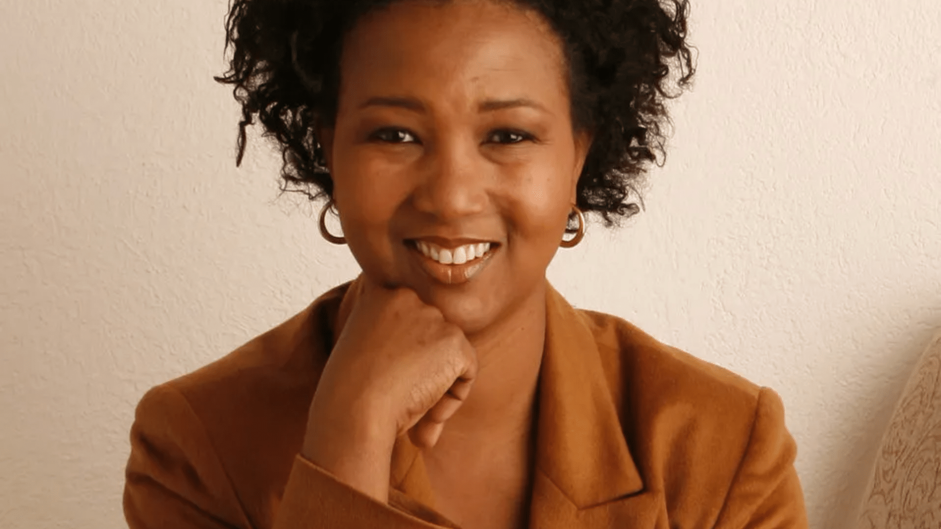 Portrait of Mae Jemison smiling in brown coat
