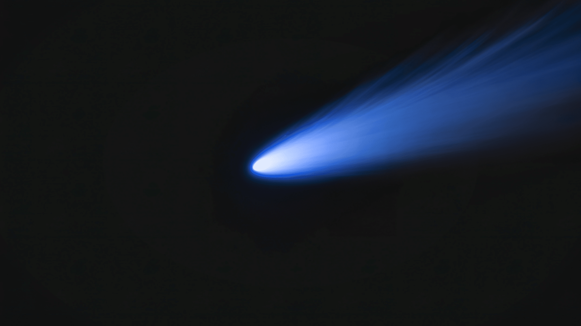 A comet with a bright tail traveling through space