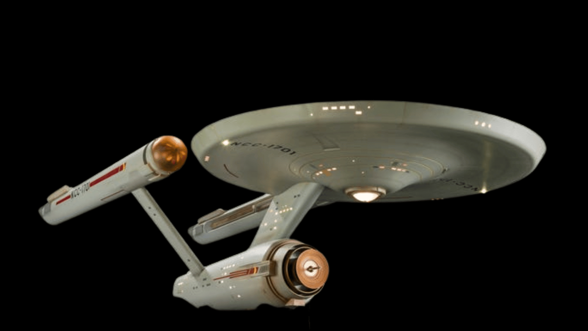 An image of USS Enterprise spaceship from Star Trek Franchise against a black background.