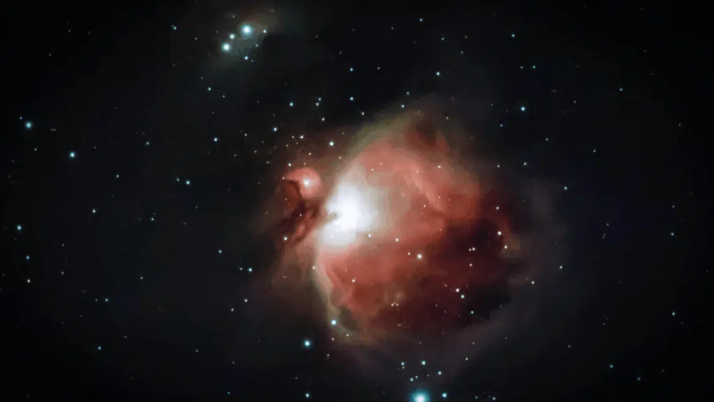 _Astrophotograph showing the reddish-pink glow of the Orion Nebula