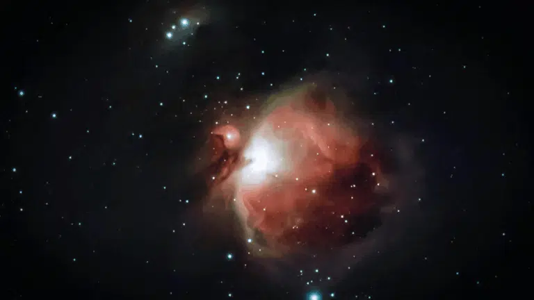 _Astrophotograph showing the reddish-pink glow of the Orion Nebula