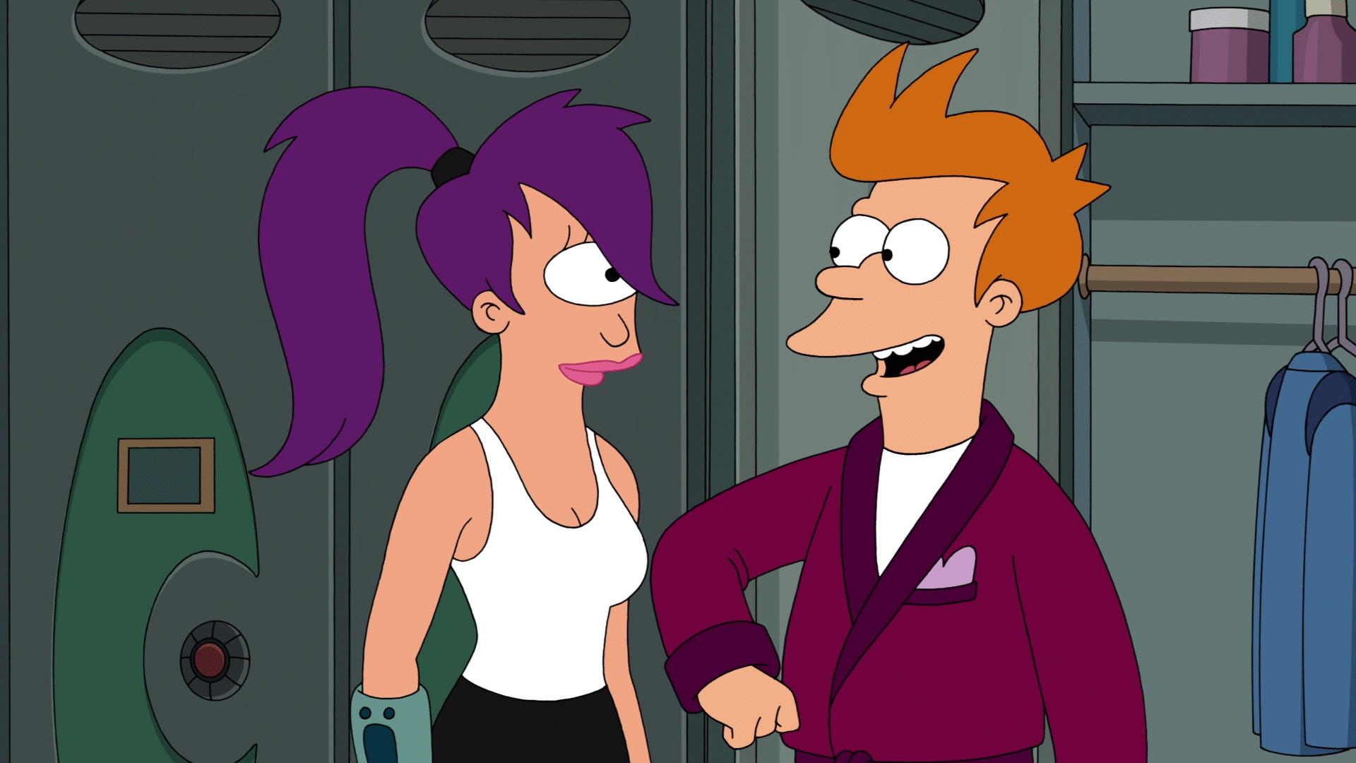 Fry in a purple robe smiles at Leela wearing a white tank top, standing in front of lockers and a closet