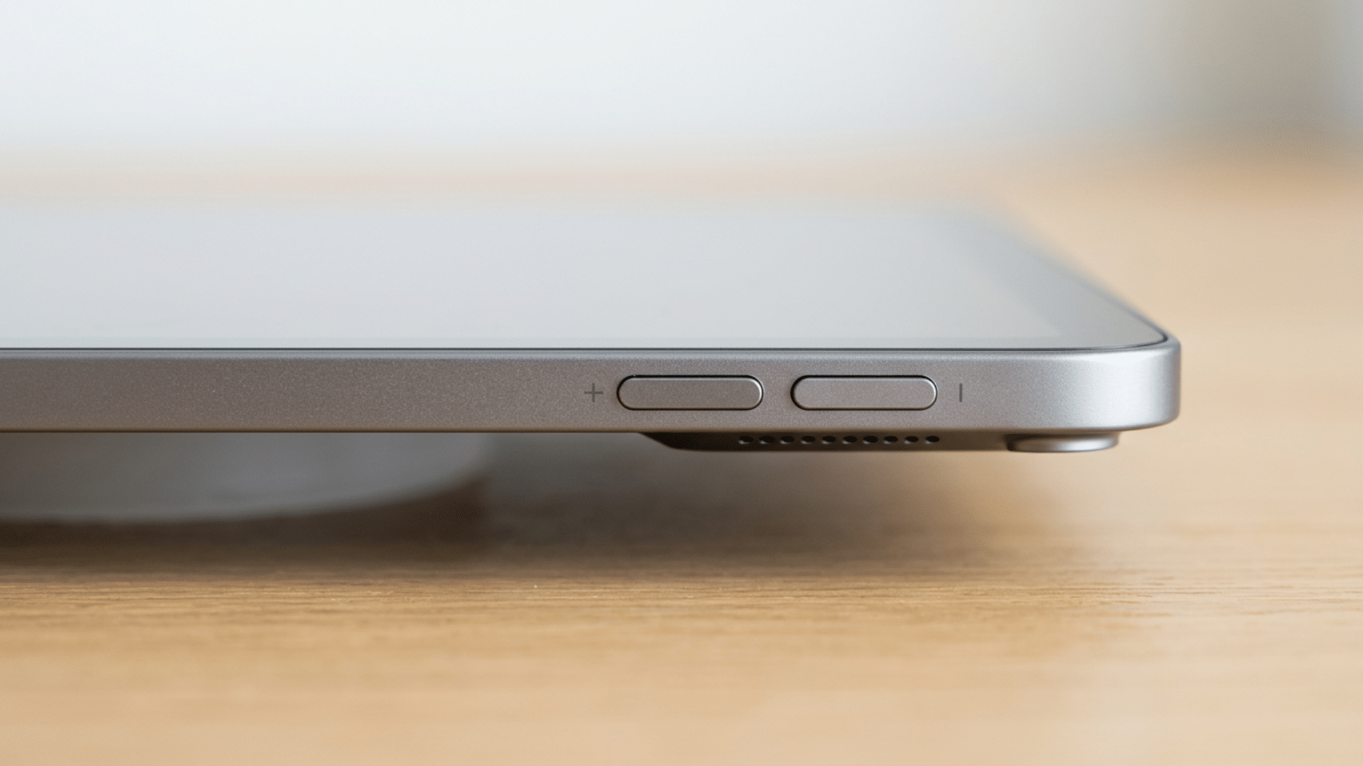 Close-up of iPad side buttons showing volume controls used to lower sound and mute alerts