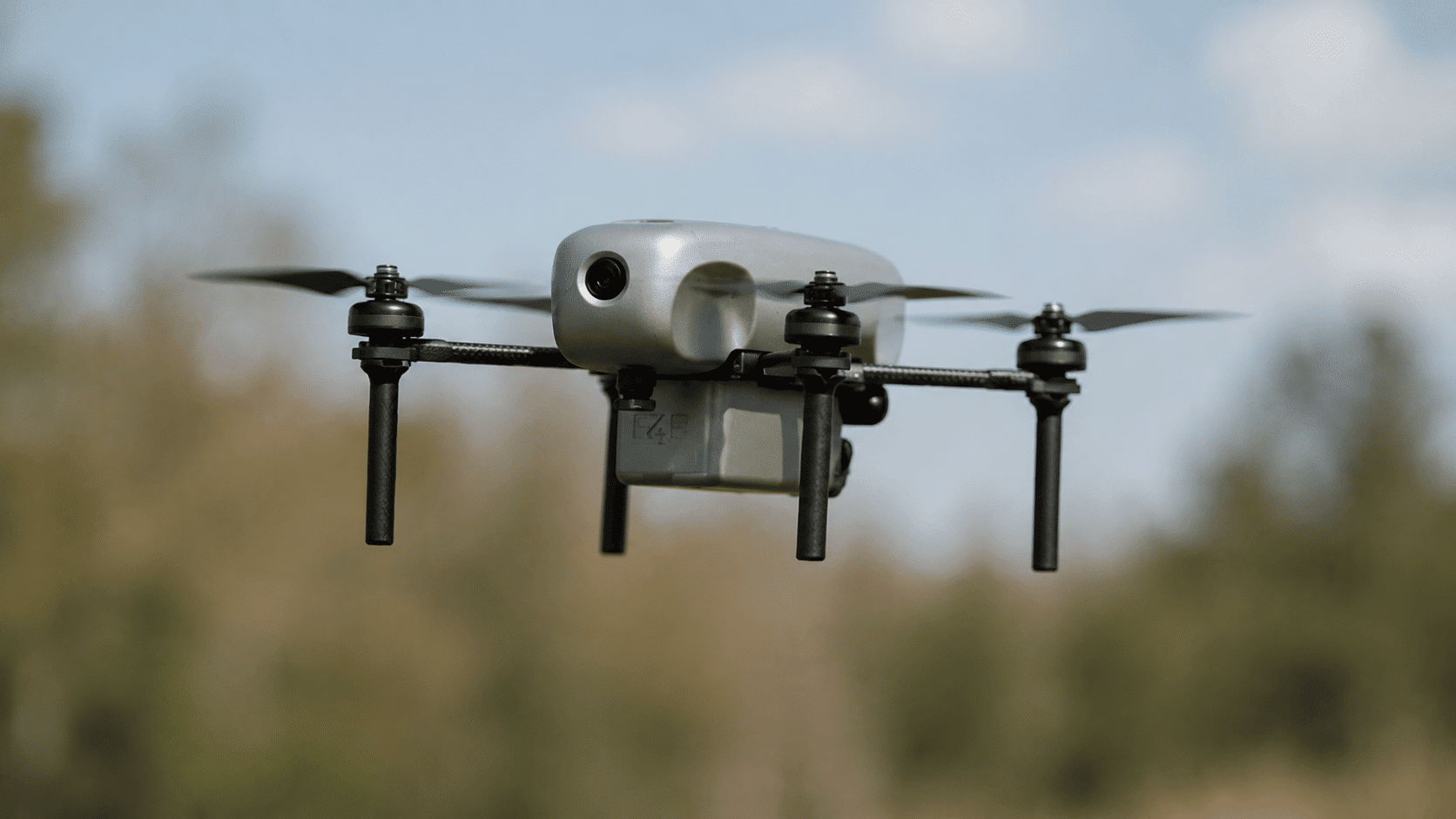 Drone flying outdoors capturing high-resolution images and environmental data from aerial perspective