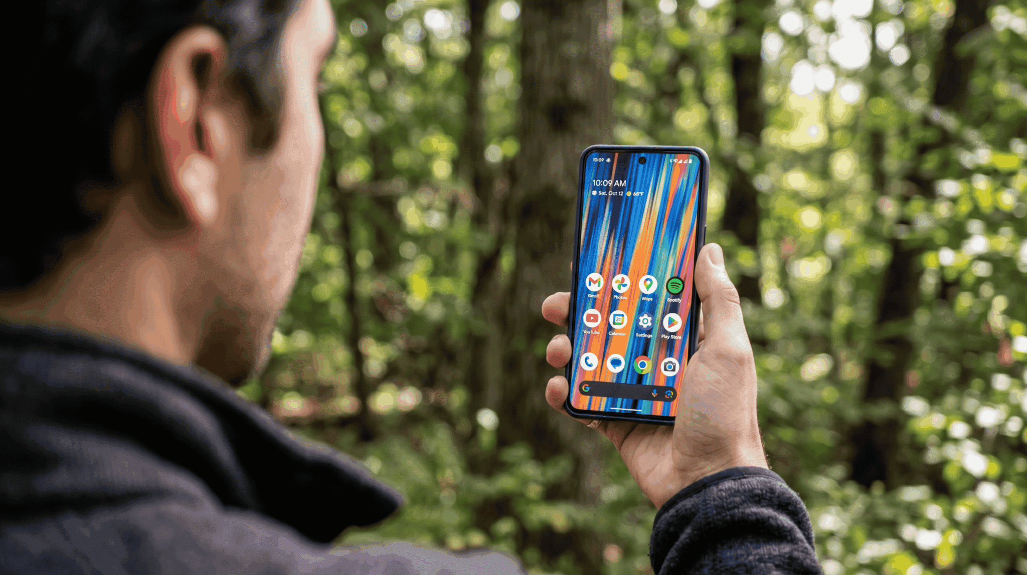 Person using Google Pixel 8 Pro outdoors in direct sunlight with screen clearly visible