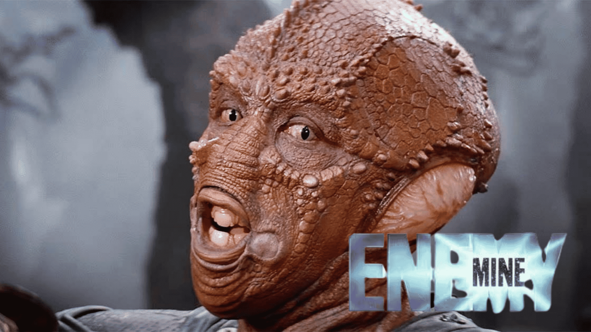 Enemy Mine movie scene featuring detailed alien character close-up.
