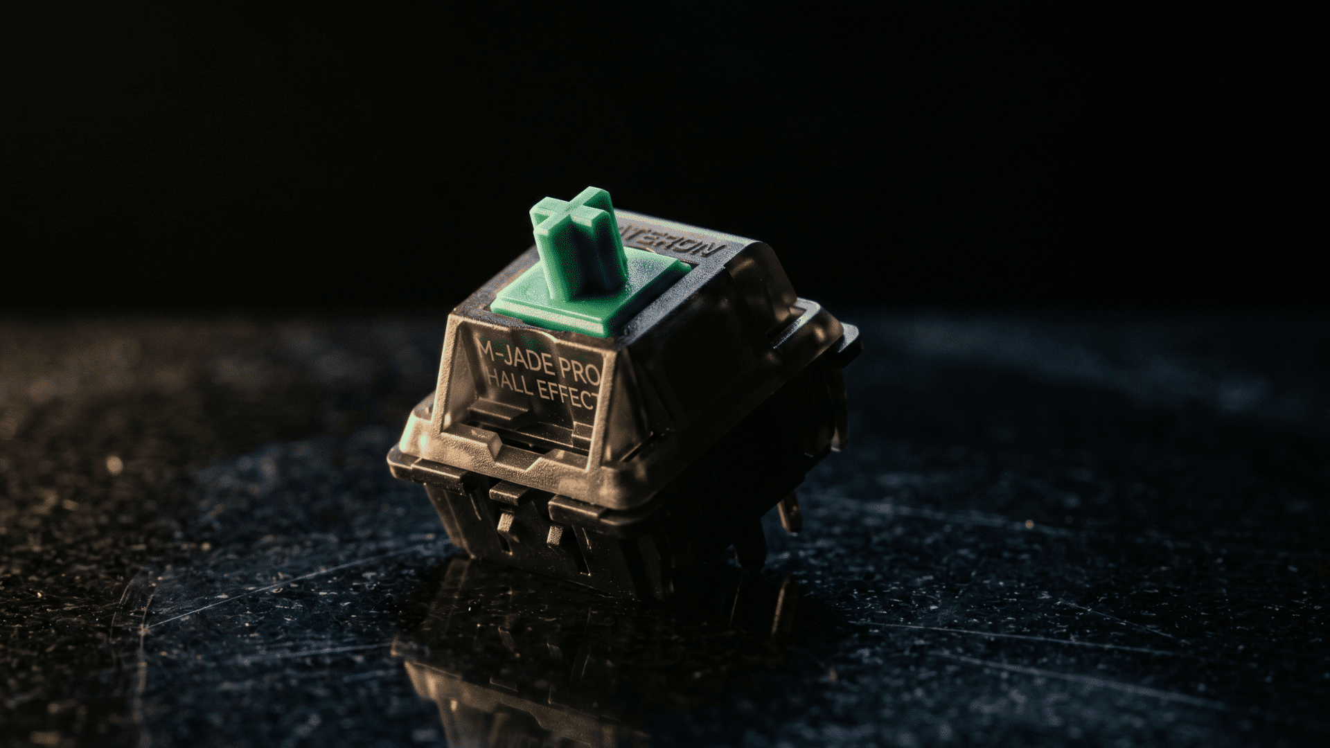 Close-up of a Gateron Magnetic Jade Pro Hall-effect switch with jade green stem, placed on a dark tech-themed surface, dramatic lighting suggesting precision and advanced technology, clean background