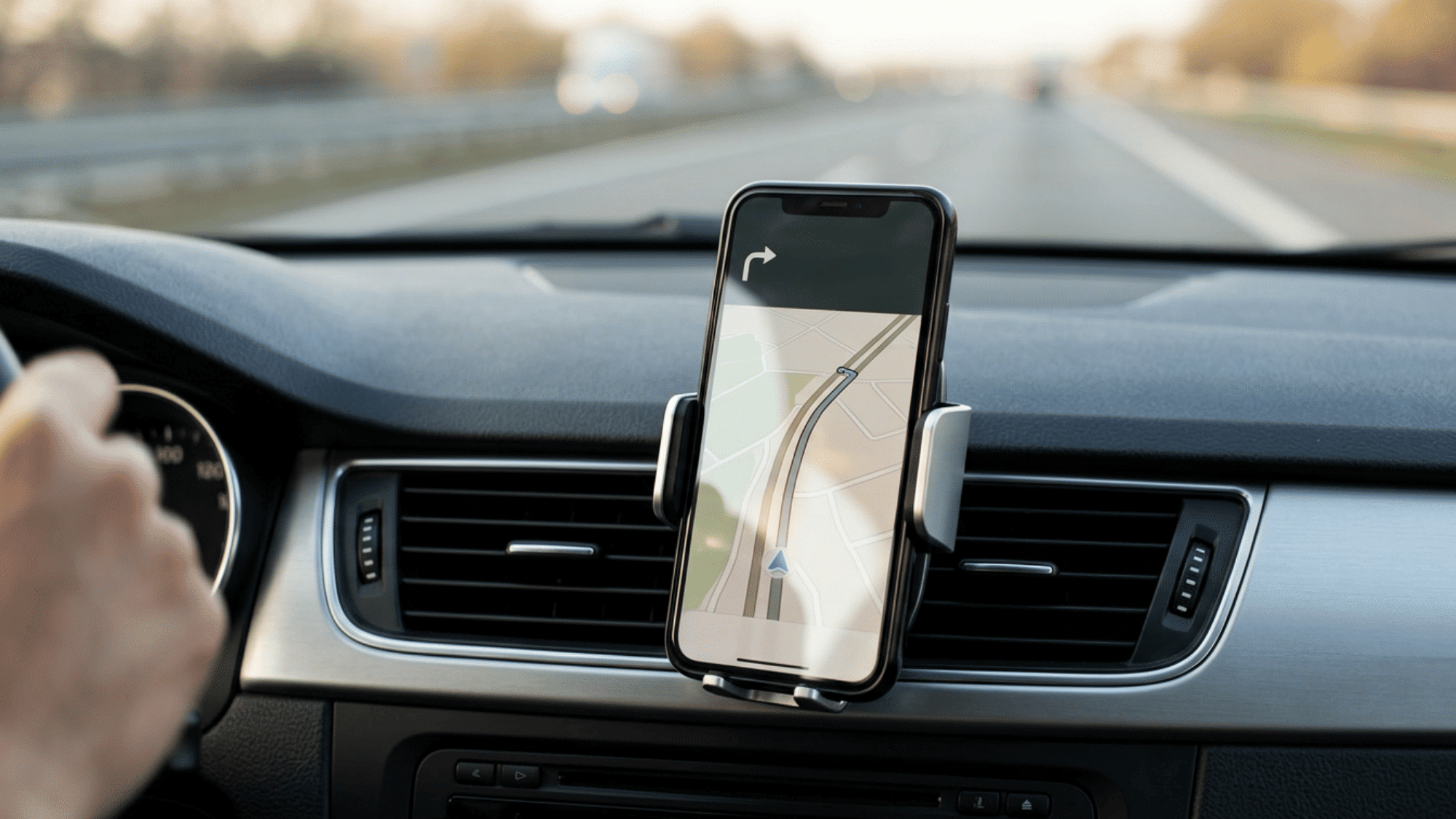 Smartphone displaying navigation app for road trip planning mounted on car dashboard