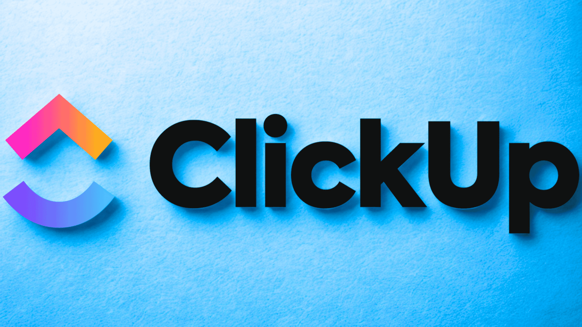 ClickUp logo with colorful icon and bold black text on a light blue textured background.