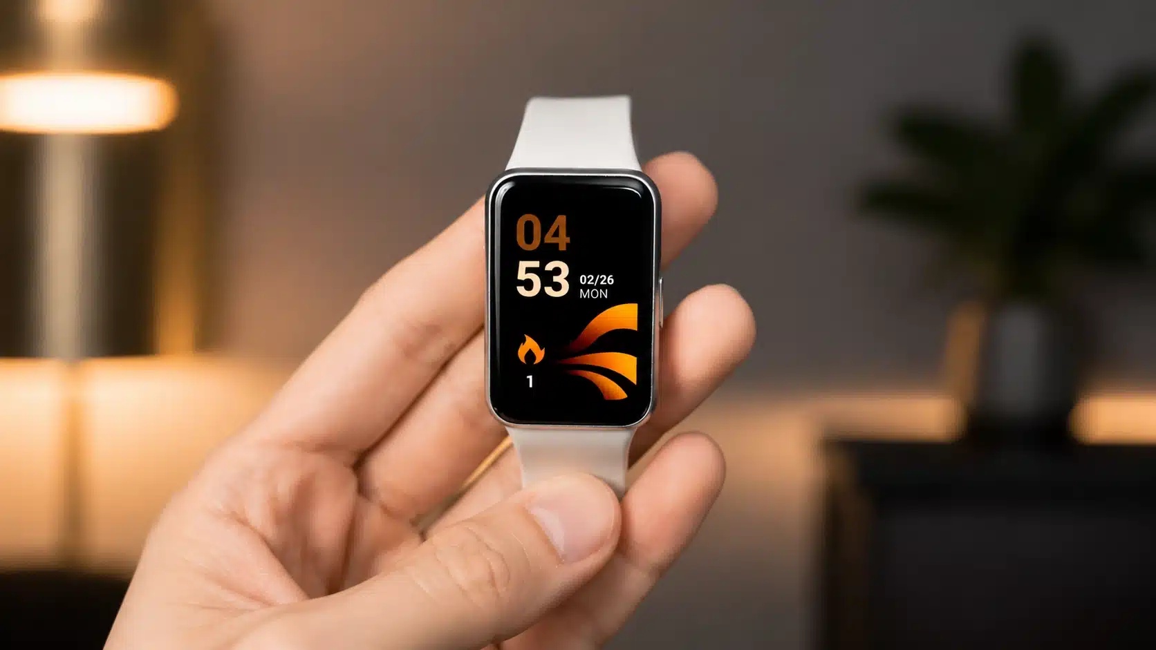 close-up of a smartwatch held in hand showing digital display and white band with blurred background