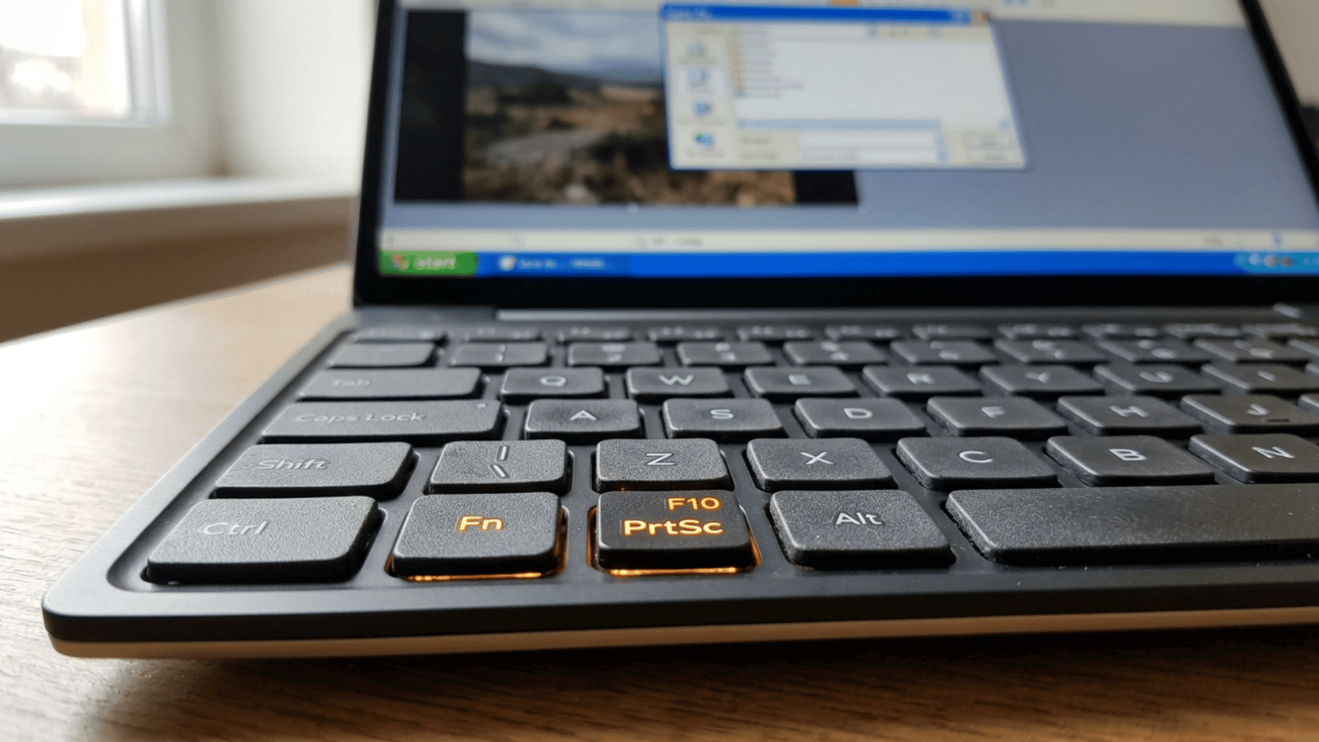 Fn and F10 PrtSc keys highlighted on a laptop keyboard.