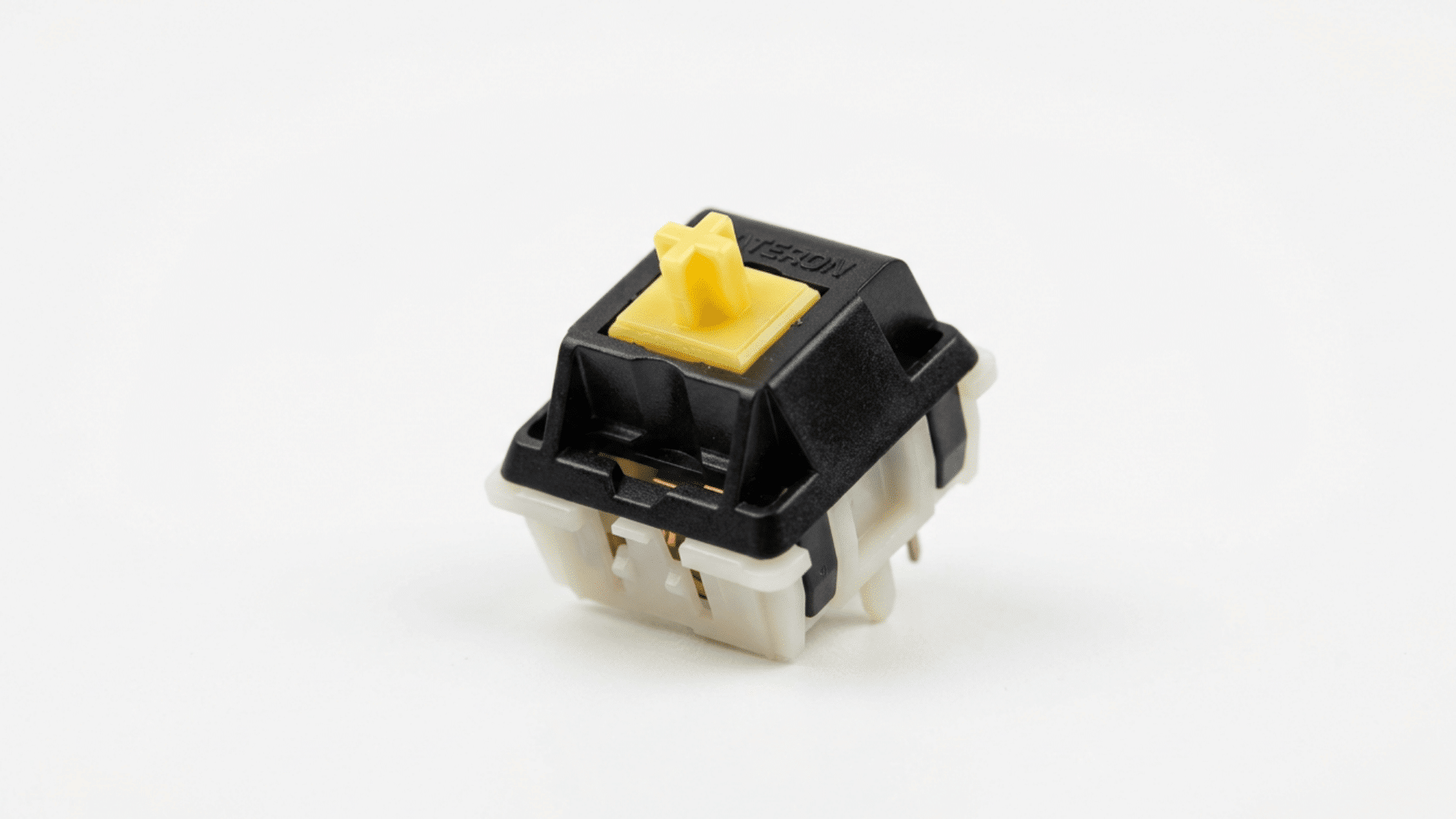Gateron Yellow switch with black housing and yellow stem on white background