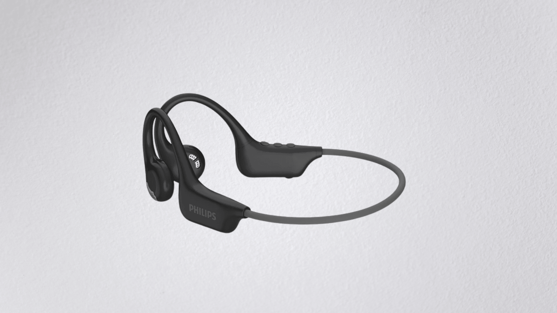 philips go series open-ear headphones placed beside casual fitness accessories