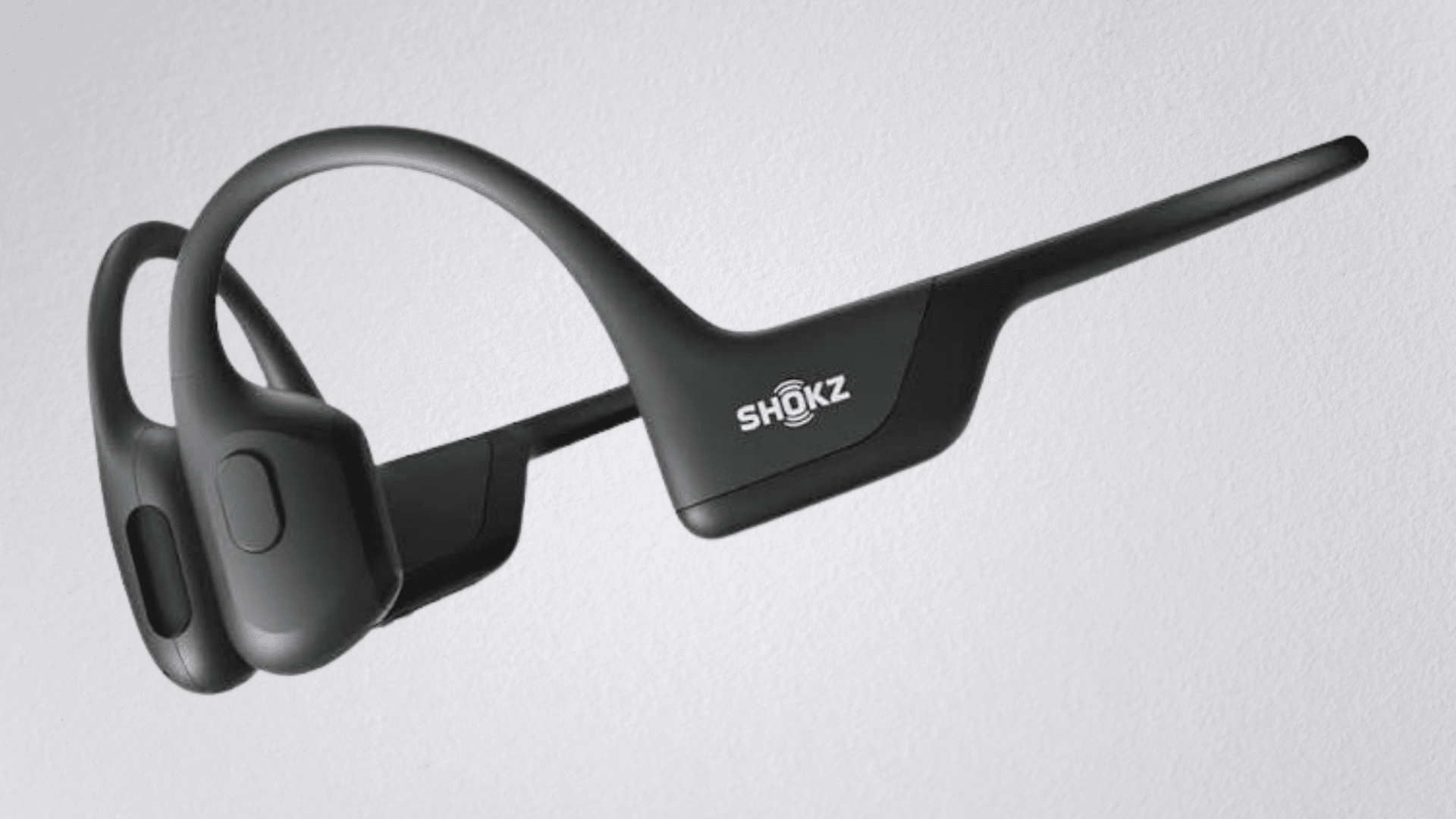 shokz openrun and opencomm bone conduction headphones displayed on a clean surface