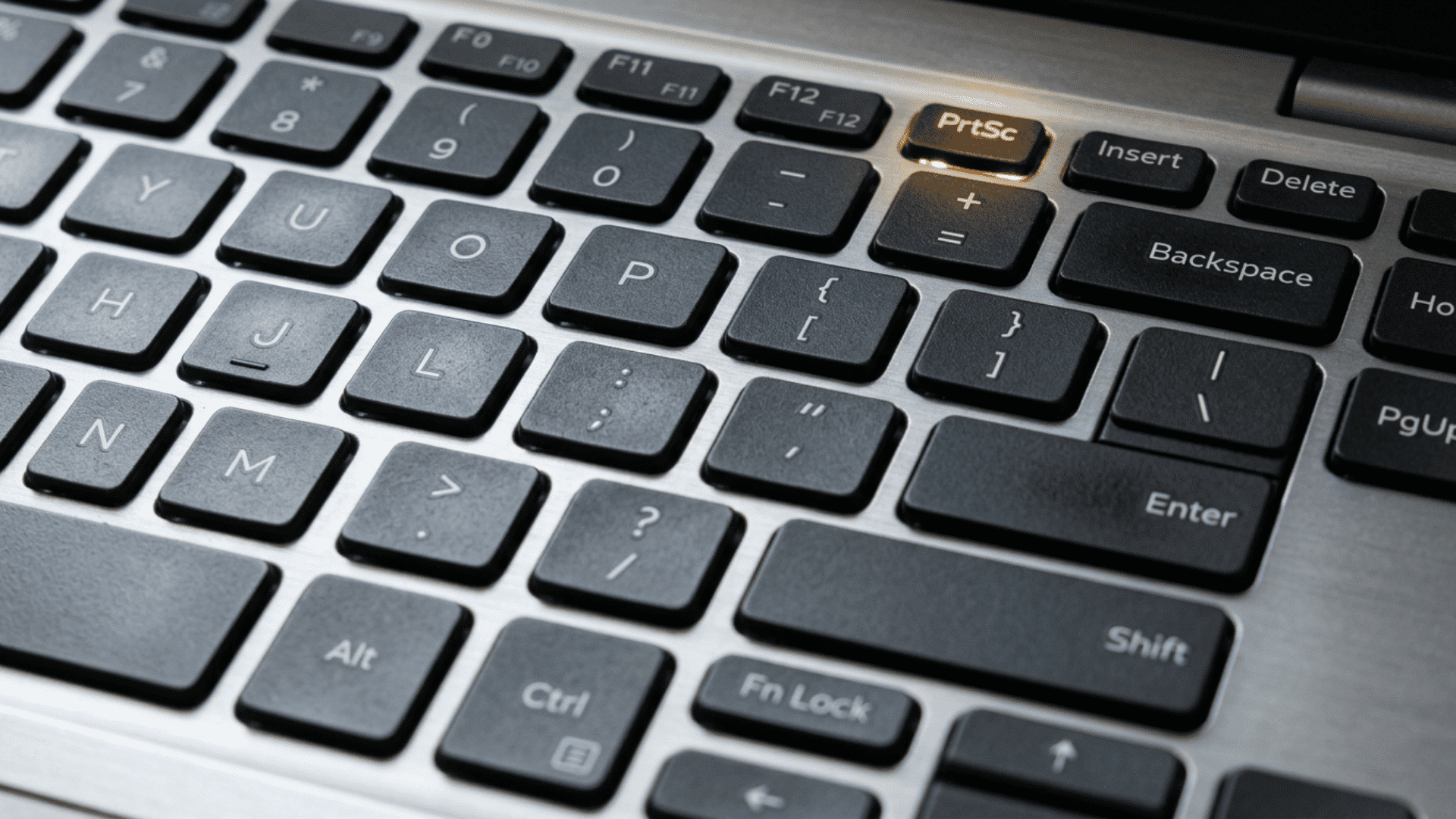 Close-up of a laptop keyboard with the PrtSc key highlighted
