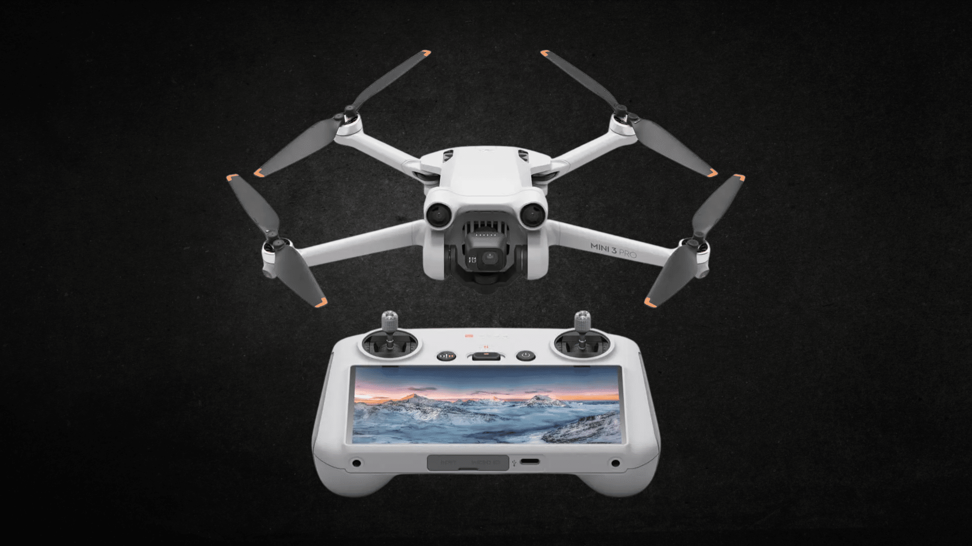 White DJI Mini 3 Pro drone hovering above its remote controller displaying a landscape on its screen