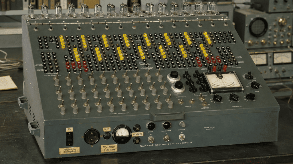 vintage analog computer with vacuum tubes and controls in a mid-century electronics lab