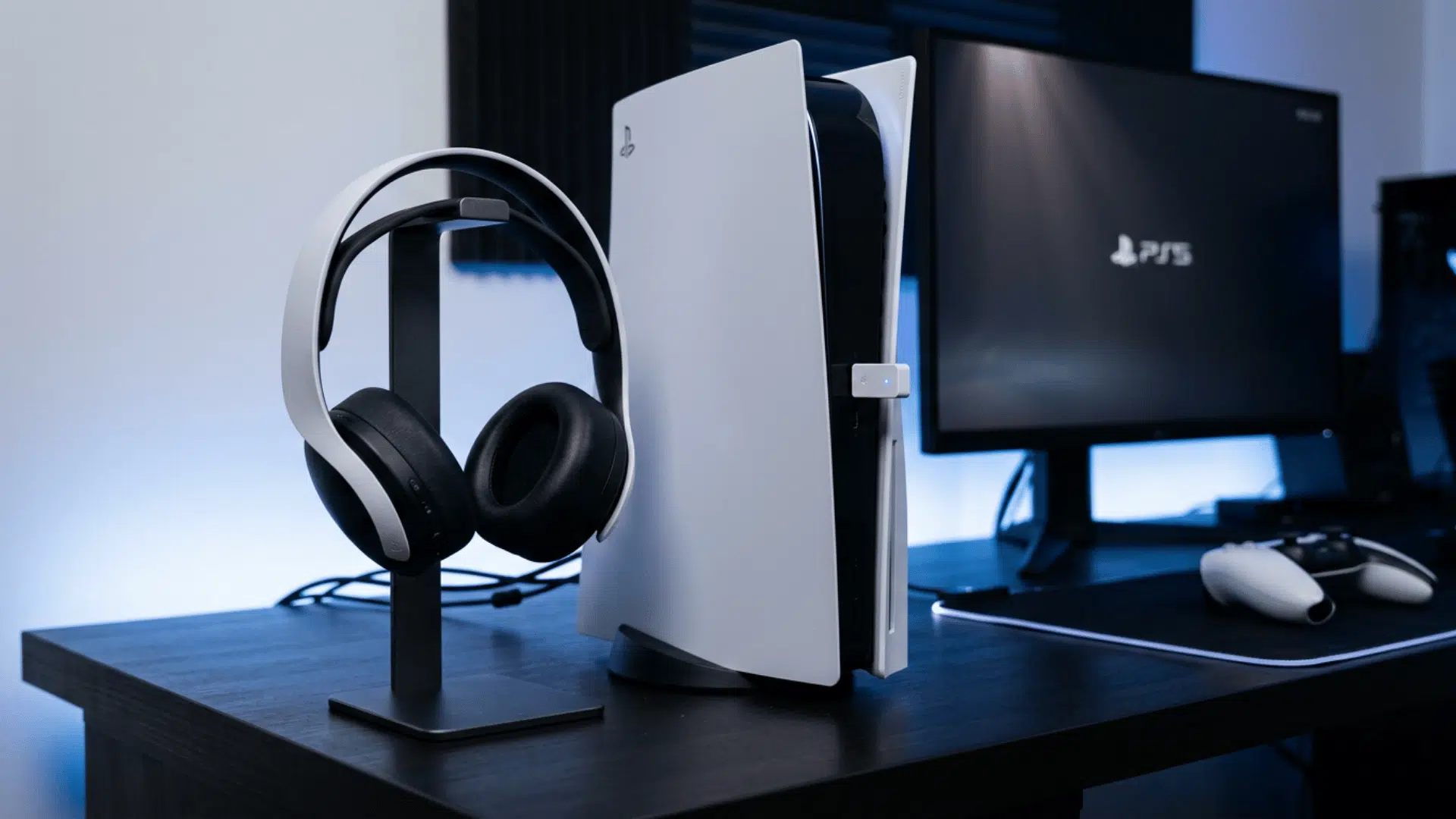 Bluetooth headphones beside a PS5 console with a USB transmitter connected