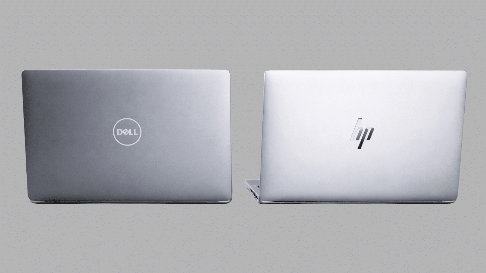 dell laptop and hp laptop shown side by side from the back, comparing their logo and lid design