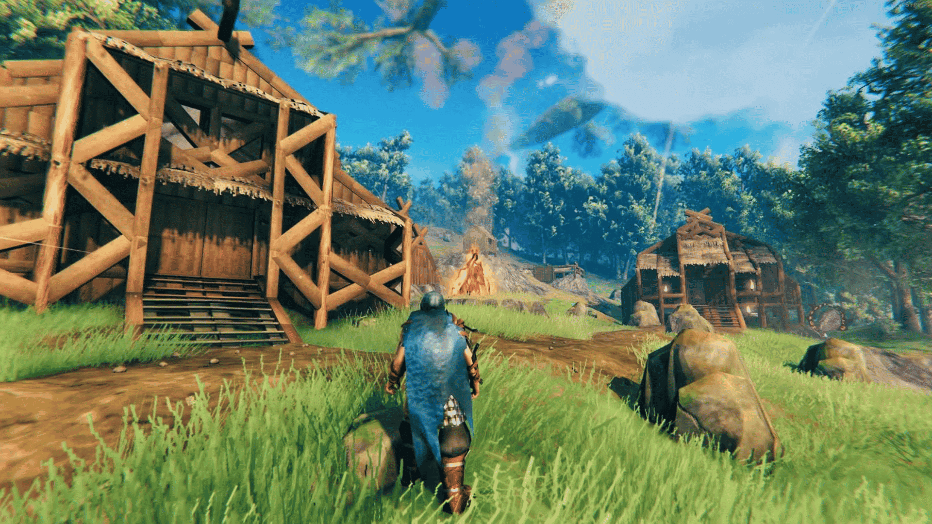 valheim warrior walking through a grassy settlement with large wooden buildings